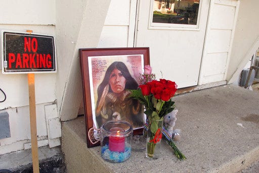 A makeshift memorial to Savanna Greywind featuring a painting, flowers, candle and a stuffed animal is seen on Monday, Aug. 28, 2017, in Fargo, N.D., outside the apartment where Greywind lived with her parents. Police say the body of Greywind was discovered Sunday night in the Red River north of Moorhead, Minn. Greywind was eight months pregnant when she went missing. (AP Photo/Dave Kolpack)