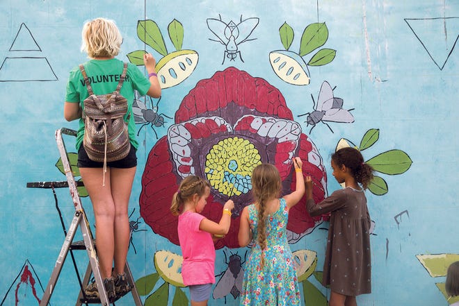 Visitors paint a community mural at the 2016 Ohio Pawpaw Festival.