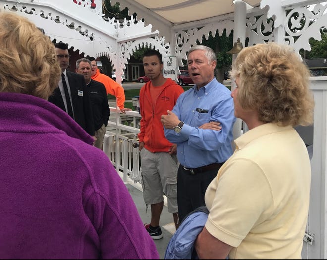 Congressman Fred Upton, R-St. Joseph, talks to Saugatuck City Councilmembers while riding the histotic Saugatuck Chain Ferry on August 24, 2017. [Jake Allen/Sentinel]