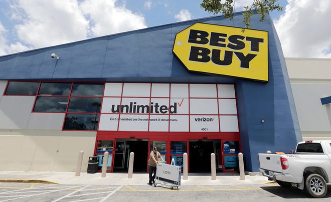 In this Monday, May 22, 2017, photo, Edward Calixto walks out of a Best Buy store with his purchased LED TV, in Hialeah, Fla. Best Buy Co., Inc. reports earnings, Tuesday, Aug. 29, 2017. (AP Photo/Alan Diaz)