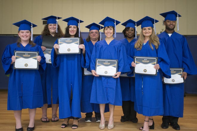 Graduates gather for a group photo at the Lake County Library System Career Online High School graduation ceremony on Wednesday. [CINDY DIAN / CORRESPONDENT]