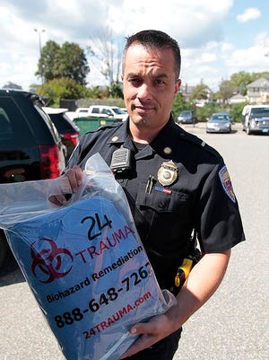 Stoughton Police Lt. John Bonney displays donated personal hazardous material protection suits outside the police department Wednesday, Aug. 30, 2017. The suits are intended to protect officers from accidental exposure to fentanyl.