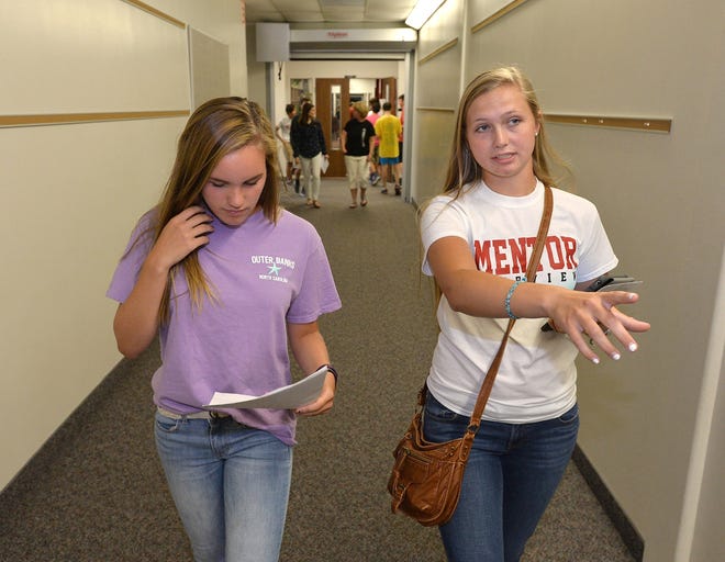 Freshman Alyssa Wingerter, 14, at left, and her mentor senior Carina Miller, 17, at right, tour Fairview High School on Aug. 23 during a freshman and new student orientation event at the Fairview Township school. Wingerter, who is new to the Fairview School District, attended Villa Elementary School last school year. [CHRISTOPHER MILLETTE/ERIE TIMES-NEWS]