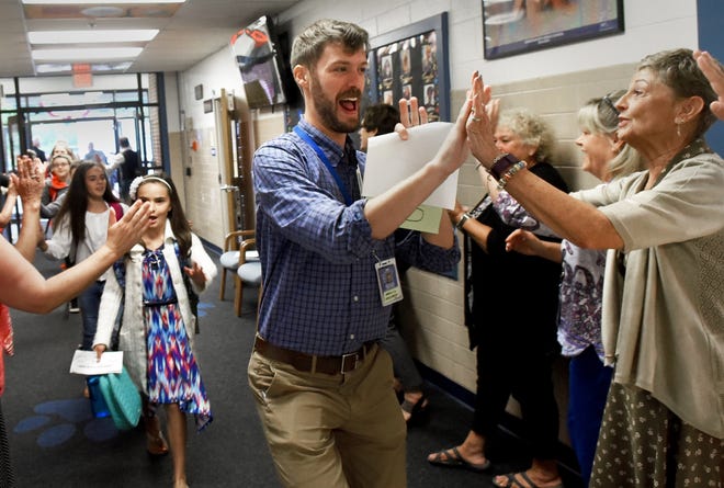 Somersworth Middle School teacher Matt Gerding welcomes students on the first day of school on Wednesday. [Deb Cram/Fosters.com]