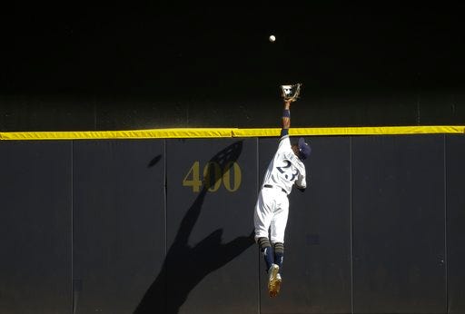 Milwaukee Brewers' Keon Broxton catches a ball at the wall hit by St. Louis Cardinals' Randal Grichuk during the ninth inning of a baseball game Wednesday, Aug. 30, 2017, in Milwaukee. The Brewers won 6-5. (AP Photo/Morry Gash)