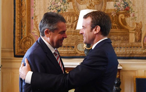French President Emmanuel Macron, right, greets German Vice Chancellor and German Foreign Minister Sigmar Gabriel upon his arrival at the Elysee presidential Palace in Paris, France, Wednesday, Aug. 30, 2017. (Alain Jocard/Pool Photo via AP)