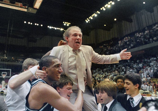 FILE - In this March 24, 1985 file photo, Villanova coach Rollie Massimino takes a victory ride on his players shoulders. Rollie Massimino, who led Villanova's storied run to the 1985 NCAA championship and won more than 800 games in his career, died Wednesday, Aug. 30, 2017 after a long battle with cancer. He was 82. (AP Photo/File)