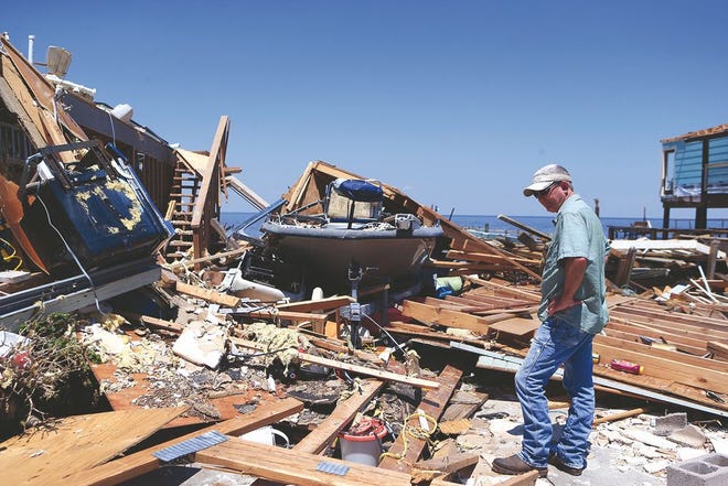 Kim Weatherford surveys the damage at his vacation home in Copano Cove in Rockport, Texas, on Wednesday. Rachel Denny Clow/Corpus Christi Caller-Times/TNS