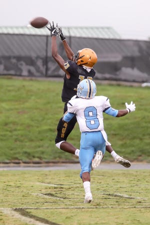 Shelby wideout Zondre Cherry (13) goes high for a pass as Burns' Kujuan Pryor (8) defends on the play in action Thursday night at Pearley Allen Field. [David Grose/Special to the Star]