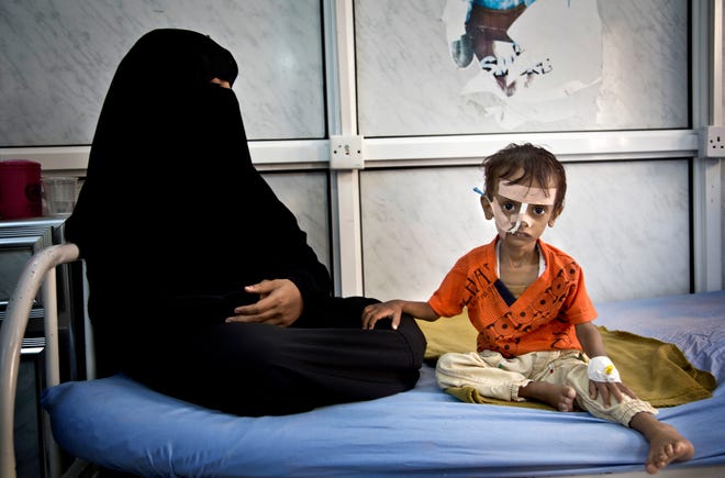 In an undated handout photo, a woman and Yemeni child in Sana'a, Yemen. Yemen, always an impoverished country, has been upended for two years by fighting between the Saudi-backed military coalition and Houthi rebels and their allies. [Marco Frattini/World Food Program via The New York Times]