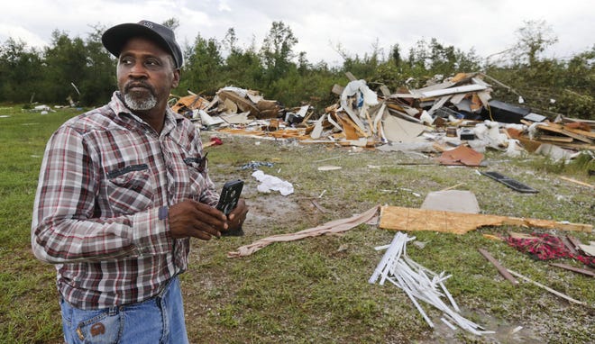 Wayne Doss surveys the damage to his cousin Danny Doss's mobile home which was completely destroyed by a tornado on Highway 17 in the Palmetto community north of Reform in Pickens County Thursday, August 31, 2017. The storm was spawned by the remain so Hurricane Harvey as thunderstorms moved through west Alabama Thursday afternoon.[Staff Photo/Gary Cosby Jr.]