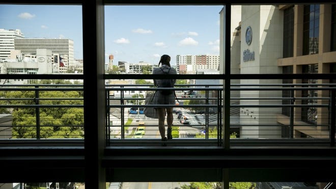 Kaya Pino of Toronto relaxes on a balcony during this year’s South by Southwest events at the Austin Convention Center. Austin City Council members are debating a proposal to expand the center.