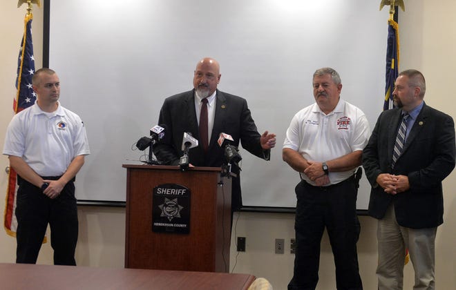 Jimmy Brissie, far left, has been named Henderson County Emergency Services Director. He's shown here with Sheriff Charles McDonald, Mills River Fire & Rescue Chief Rick Linvingston and Transylvania County Sheriff David Mahoney at a news conference July 31.