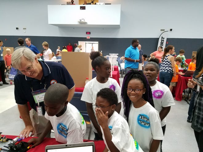 Fort Walton Beach Mayor Dick Rynearson reviews a First Lego League team project at a recent FLL event. [SPECIAL TO THE DAILY NEWS]