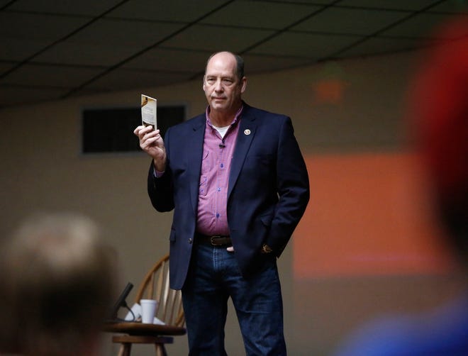 U.S. Rep. Ted Yoho, R-Gainesville, holds up his pocket Constitution as he speaks at a town hall event in March 4. [Brad McClenny/The Gainesville Sun]