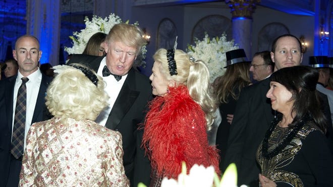 Donald Trump, then president-elect, speaks with Lois Pope, in red, on New Year’s Eve 2016 at Mar-a-Lago.