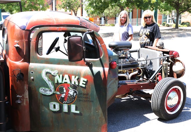 Regina Mitchell of Greenville, Texas, left, and Debbie Kelley of Trinidad, Texas, look over one of the rat rods being entered in the Rats to Riches Rat Rod Car Show on Friday, Sept. 1, 2017, at the Fort Smith Convention Center. Hosted by Rats to Riches and 3 Nuts Customs Fab Shop, the show features ratrod cars, ratbikes, shop trucks as well as concerts, tattoos on site, vendors and a swap meet. A cruise night will begin at 5 p.m. Saturday, Sept. 2, 2017, between 2nd Steet and 13th Street along Garrison Avenue. The show runs Saturday, Sept. 2, 2017, through Sunday, Sept. 3, 2017 from 8 a.m. to 8 p.m., admission is $10 per person, ages 12 and under are free and all tickets are available at the gate only and good for all related events. [JAMIE MITCHELL/TIMES RECORD]