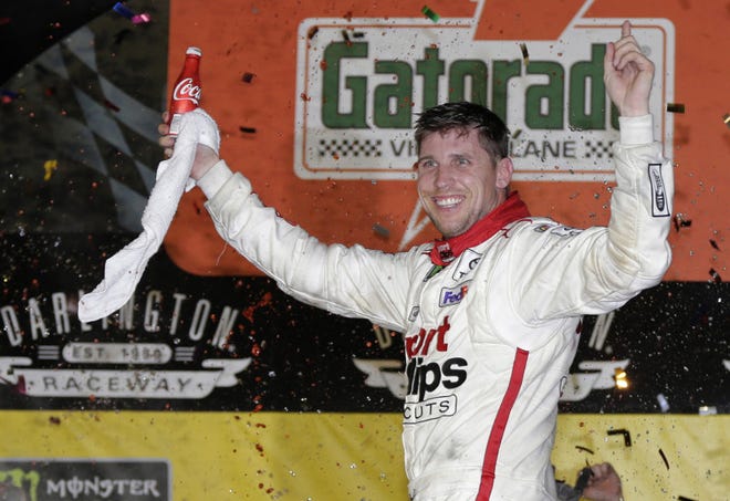 Denny Hamlin celebrates in Victory Lane after winning the NASCAR Monster Cup race at Darlington Raceway, Sunday in Darlington, S.C. (AP Photo/Terry Renna)