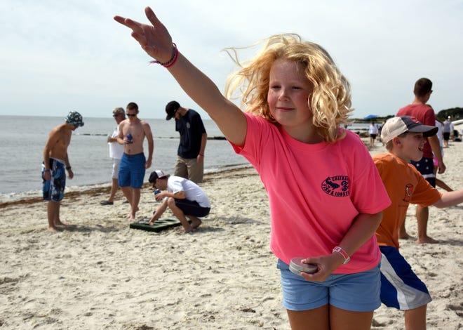 Lily Plotner, 10, of Needham, tries her hand at the game during the 10th annual Nantucket Sound Grunt Tournament on Sea Breeze Beach.
