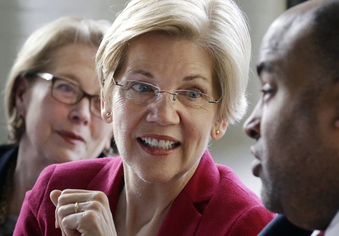In this March file photo, Sen. Elizabeth Warren, D-Mass., center, smiles during a small business roundtable discussion in Lawrence. The Republican campaign to oust Warren in November 2018 is starting to shape up and it's pitting the conservative wing of the party against its more moderate middle. [AP Photo/Elise Amendola, File]