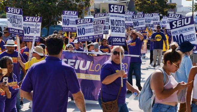 Service Employees International Union, SEIU, gather for a Labor Day rally in downtown Los Angeles on Monday.