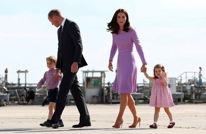 Britain's Prince William and his wife Kate, the Duchess of Cambridge, and their children, Prince George, left, and Princess Charlotte, walk on their way to board a plane in Hamburg, Germany, in July. Kensington Palace says Prince William and his wife, the Duchess of Cambridge, are expecting their third child.