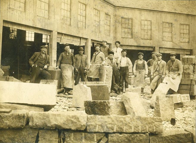 In this photo from the early 1900s, granite workers at Quincy's Pearce and Clark Quarry are shown with manager George Clark, left, and Edward Pearce, second from left. The granite cutters union was prominent in the city.