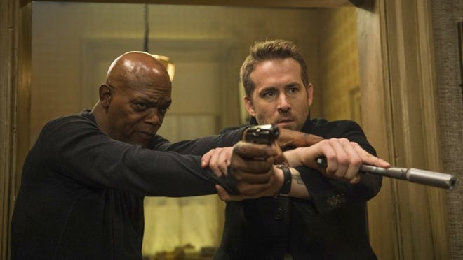 Samuel L. Jackson, left, and Ryan Reynolds star in “The Hitman’s Bodyguard.” The action comedy was No. 1 again over Labor Day weekend. Jack English/Lionsgate via AP