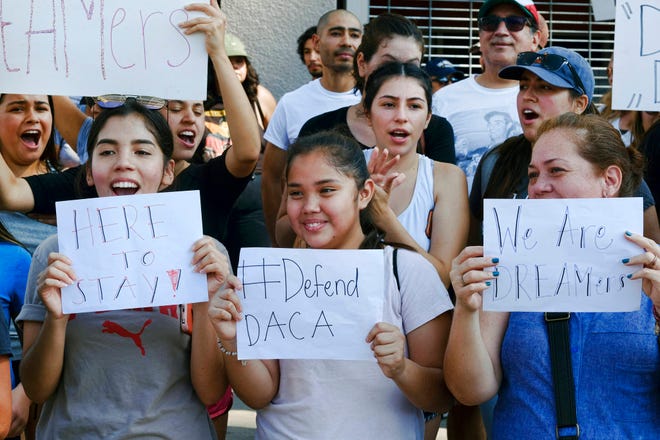 Supporters of the Deferred Action for Childhood Arrivals, or DACA, chant slogans and holds signs while joining a Labor Day rally in downtown Los Angeles on Monday, Sept. 4, 2017. President Donald Trump is expected to announce this week that he will end the Deferred Action for Childhood Arrivals, but with a six-month delay, according to two people familiar with the decision-making. (AP Photo/Richard Vogel)