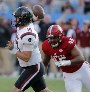 South Carolina's Jake Bentley (19) fires off a pass just before N.C. State's Darian Roseboro (45) on the pass rush during the second half of an NCAA college football game in Charlotte last Saturday. [AP Photo/Bob Leverone]