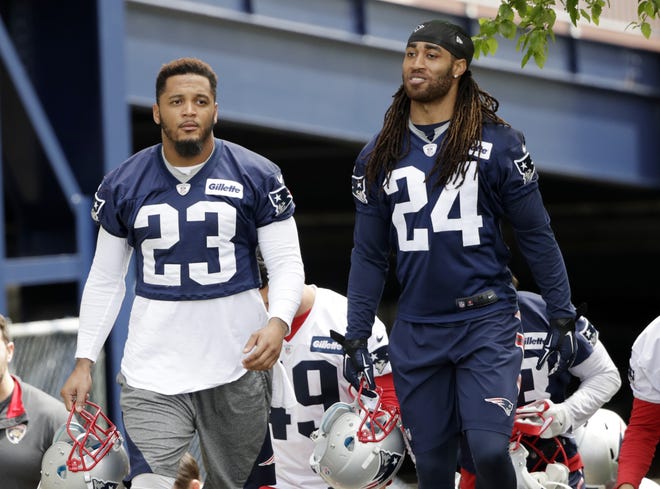 Patriots cornerback Stephon Gilmore (right), shown walking onto the practice field in June with safety Patrick Chung, should form one of the top cornerback duos in the NFL with Malcolm Butler (not pictured).