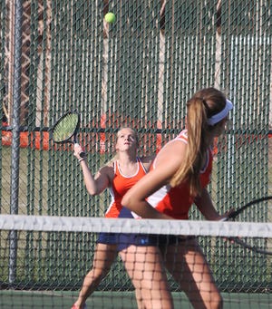 Pontiac’s Ashley Branz looks back as doubles teammate Megan Eck makes a return during tennis play at the Williamson Field Courts Tuesday afternoon. Branz and Eck were winners in doubles and singles play in a 7-2 PTHS win.