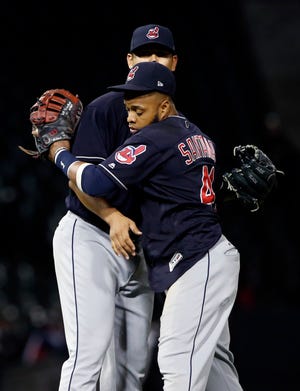Cleveland Indians' Carlos Santana, right, celebrates with starting pitcher Carlos Carrasco after the Indians defeated the Chicago White Sox 5-1 Wednesday, Sept. 6, 2017, in Chicago.