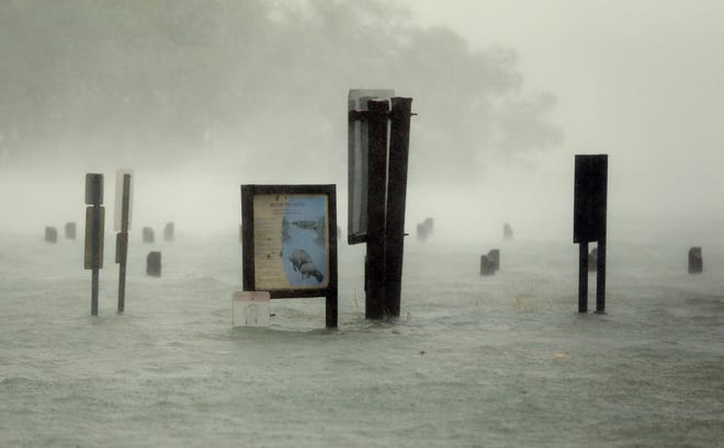 Flood waters rise around signs at the Haulover Marine Center at Haulover Park as Hurricane Irma passes by, Sunday, Sept. 10, 2017, in North Miami Beach, Fla. (AP Photo/Wilfredo Lee)