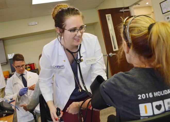 Wingate students help out at a health fair at the Health Sciences Center in April. [PROVIDED PHOTO]