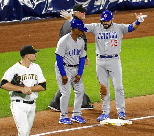 Chicago Cubs' Alex Avila (13) celebrates with coach Gary Jones, center, as he stands on third base after driving in the Cubs' only run with a triple off Pittsburgh Pirates relief pitcher Daniel Hudson, left, in the ninth inning of a baseball game in Pittsburgh, Wednesday, Sept. 6, 2017. The Cubs won 1-0. (AP Photo/Gene J. Puskar)
