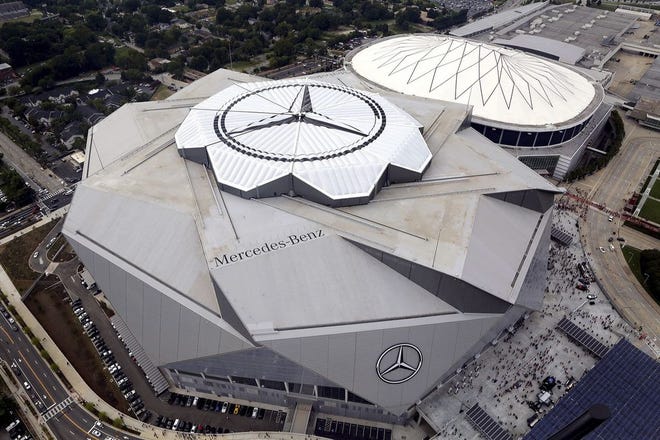 The new Mercedes-Benz Stadium, foreground, stands next to the Georgia Dome in aerial photo.