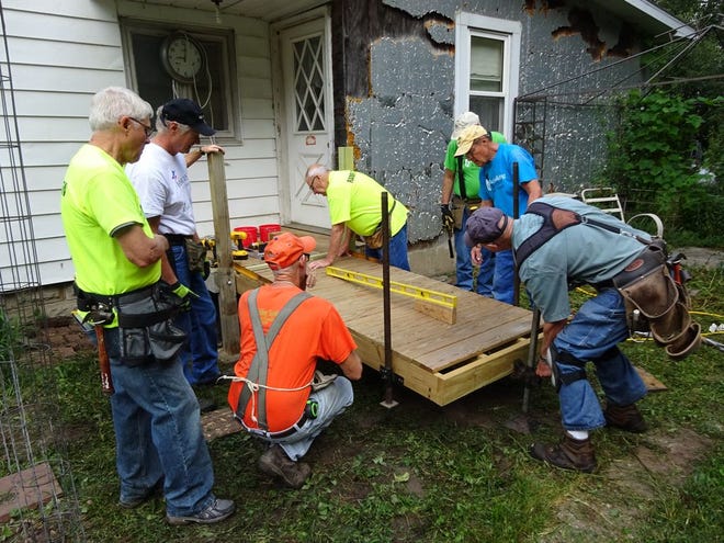 Volunteers with Rebuilding Together Henry County install the organization’s 150th wheelchair ramp on Thursday, Aug. 31. Pictured are, counterclockwise from left: Jim Sorenson, Terry Sears, Jim Snyder, Ted Blean, Greg Patton, Dick 
VanKeerebroeck and Don Simpson.