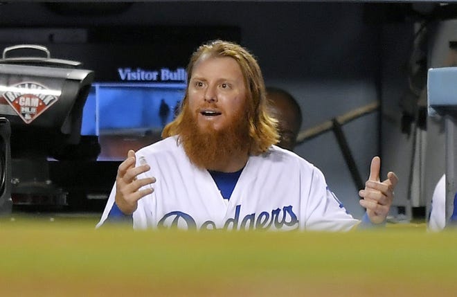 Los Angeles Dodgers' Justin Turner gestures in the dugout after being ejected by home plate umpire Chad Fairchild on Wednesday against the Arizona Diamondbacks. [AP Photo/Mark J. Terrill]