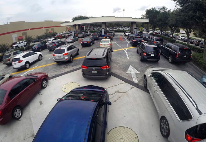 Drivers wait in line for gasoline in Altamonte Springs, Fla., ahead of the anticipated arrival of Hurricane Irma, Wednesday, Sept. 6, 2017. Irma roared into the Caribbean with record force early Wednesday, its 185-mph winds shaking homes and flooding buildings on a chain of small islands along a path toward Puerto Rico, Cuba and Hispaniola and a possible direct hit on densely populated South Florida. (Joe Burbank/Orlando Sentinel via AP)