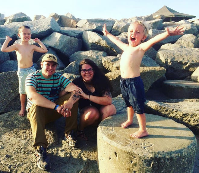 Derek and Emily Klinefelter with their biological sons Lyric (left), 6, and Jude, 4, at Fort Fisher. The family opens their home to foster children, and have started a Foster Pantry to provide necessities for children entering the foster system. [Courtesy of Chelsea Fishman]