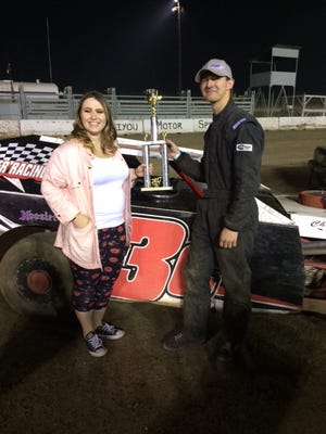 Colton Cheffey and his sister Jeni hold the trophy he won for his fifth victory in a row at Siskiyou Motor Speedway Sept. 2, 2017, the night he circled the track and used a CO2 bottle in his car to shoot blue powder out of a plastic tube to reveal the gender of Jeni's first child. Submitted