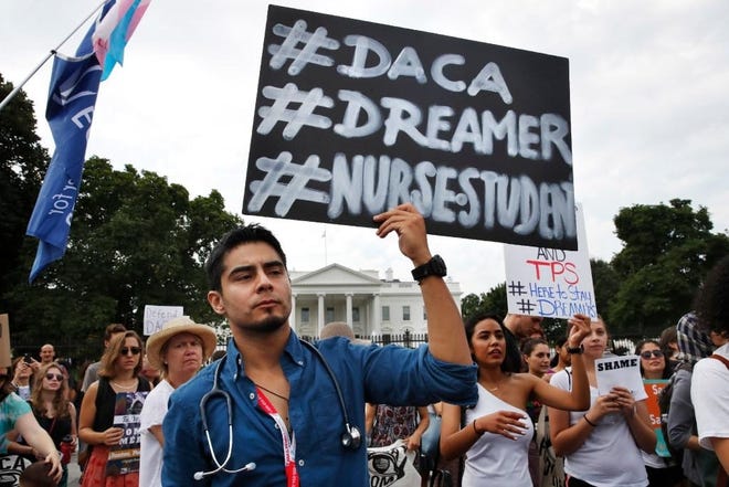 Carlos Esteban, a nursing student and recipient of Deferred Action for Childhood Arrivals, rallies with others in support of DACA outside of the White House on Tuesday. [AP Photo/Jacquelyn Martin]