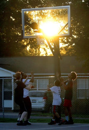 Ballplayers watch the basket while playing at Hope Community Church on Thursday. The church will partner with the Gardner-Webb men's basketball team for Bulldogs on the Blacktop on Saturday. Locals will have the opportunity to play in a 3-on-3 tournament with the GWU players. [Brittany Randolph/The Star]