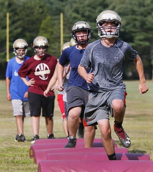 Old Colony's Phil Proctor leads a group of Cougars during agility drills. [MIKE VALERI/THE STANDARD-TIMES/SCMG]