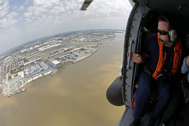 Coast Guard Marine Science Technician Petty Officer 1st class Shaun Haskins looks out at the port of Houston as he does a survey or environmental and navigational hazards in the aftermath of Hurricane Harvey on Friday, Sept. 1, in Houston. [CHARLIE RIEDEL/AP]