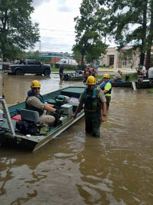 Deputy Alex Beauvais and Cpl. Sean Wallace of the Sebastian County Sheriff's Office and Mark Condren of Sebastian County Search and Rescue prepare for area patrol in Kingwood, Texas, north of Houston, on Wednesday, Aug. 30, 2017. [PHOTO COURTESY OF JOHN MILLER]