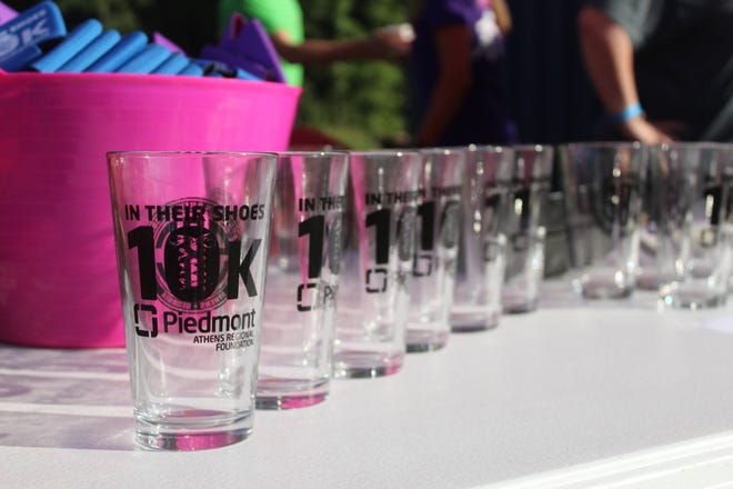 Piedmont Athens Regional’s In Their Shoes fundraiser teamed up with Southern Brewing Company for a kick-off event. Specially made pint glasses were available for $5. All proceeds from the glasses, just like the proceeds from the race, stay local to benefit the Loran Smith Center for Cancer Support. (Photo by Red Denty / Staff)