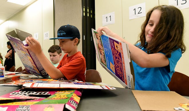 Matt Carpenter (from left), 12, of Medford, Christian Drew, 10, of Chester, and Missy Carpenter, 10, of Medford, create collage art from cereal boxes during the workshop.
