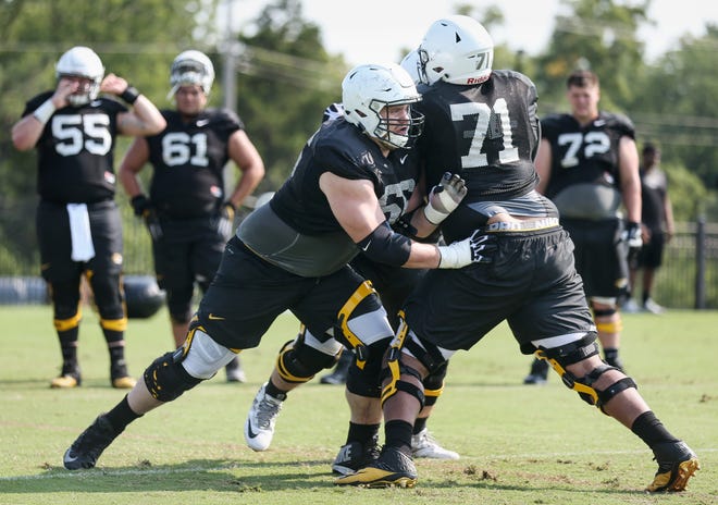 Offensive linemen Adam Ploudre (66) and Kevin Pendleton (71) are pieces of Missouri's beefed-up offensive line. The Tigers average 326 pounds across the line, the bigges in the SEC. [Timothy Tai/Tribune]